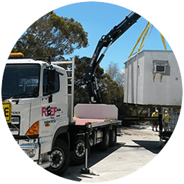 Image of our crane truck delivering a donga